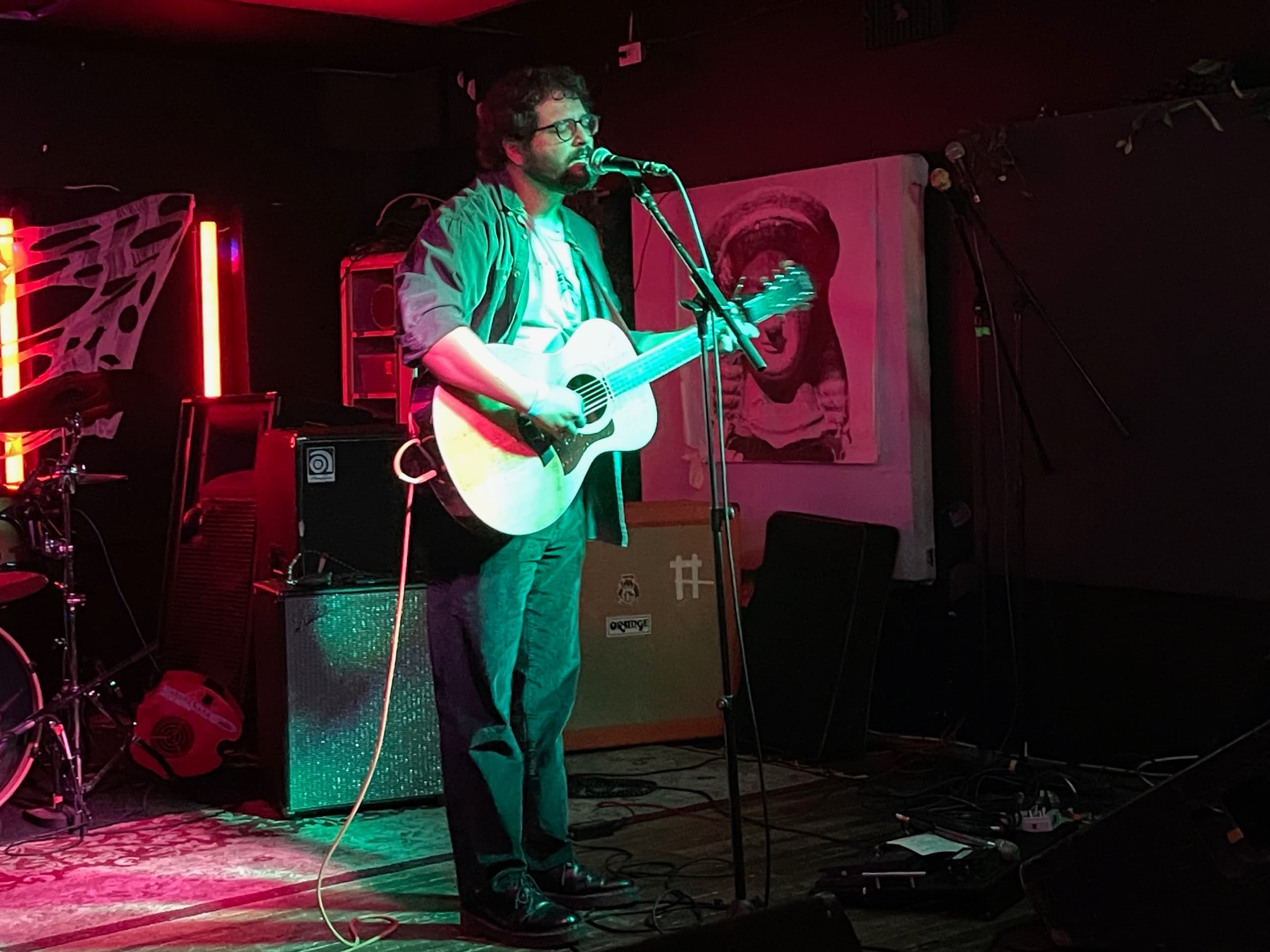 Alex Beckman playing acoustic guitar and singing